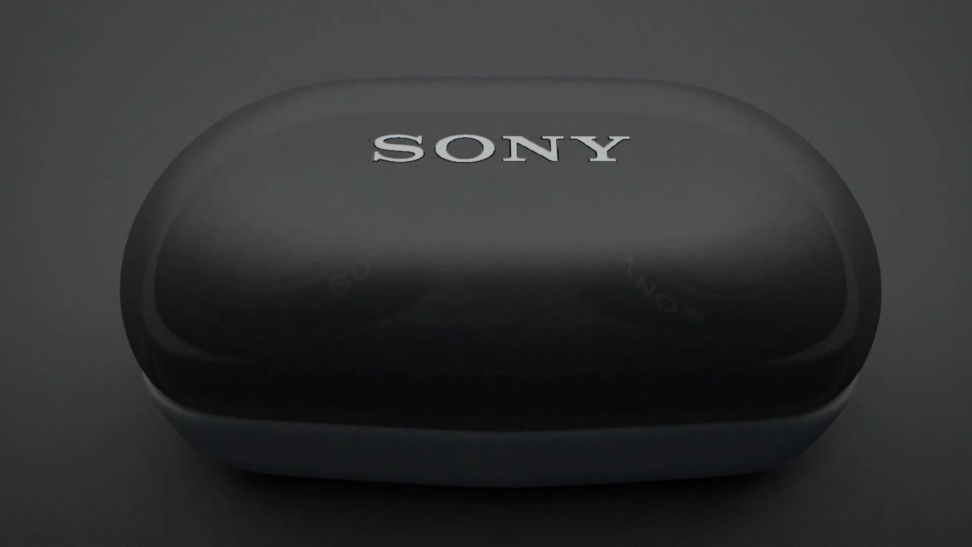 Black wireless earbuds and their case on a dark surface