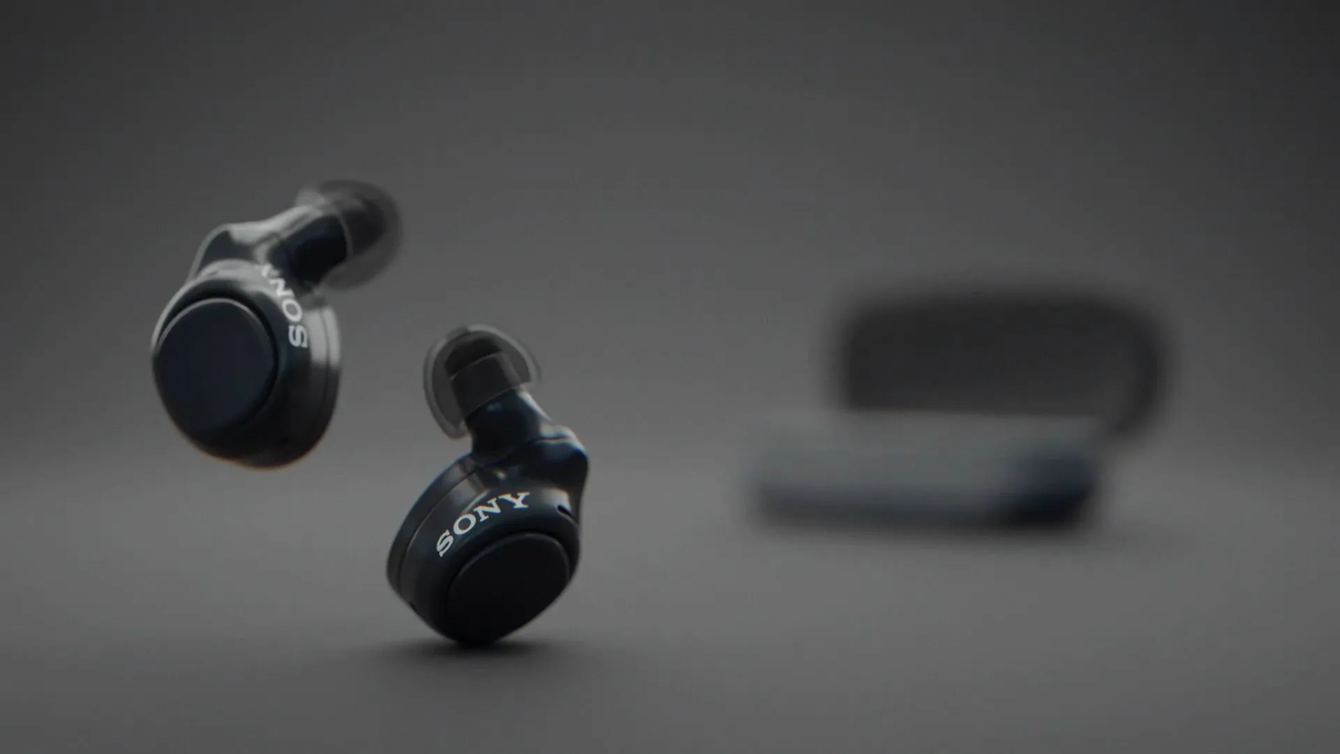 Mint-green earbuds tumbling against a matching background