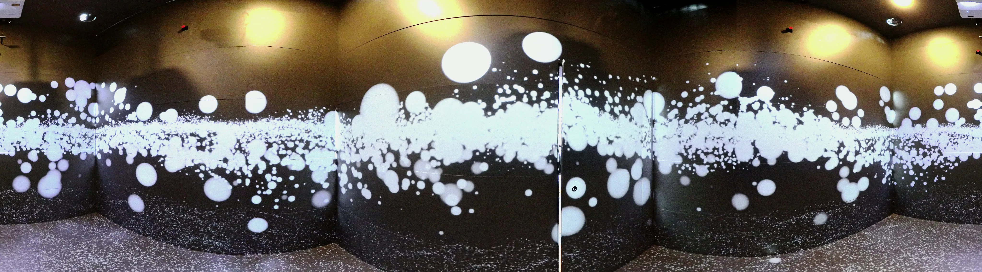 Panorama of the room: white spheres drifting across every surface