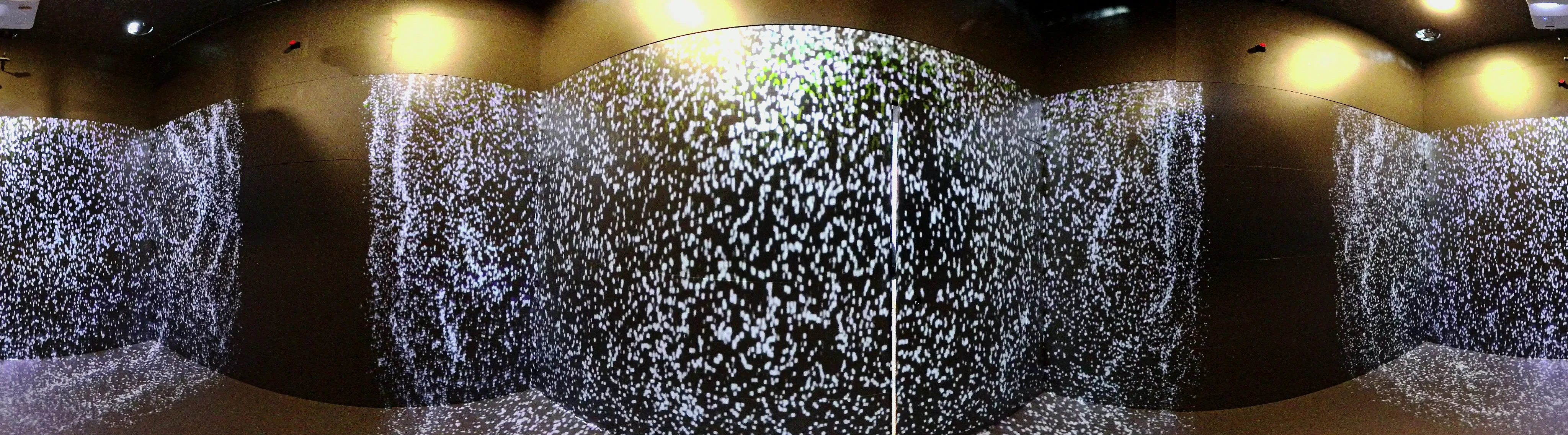 Panorama of the room: a wall of white particles