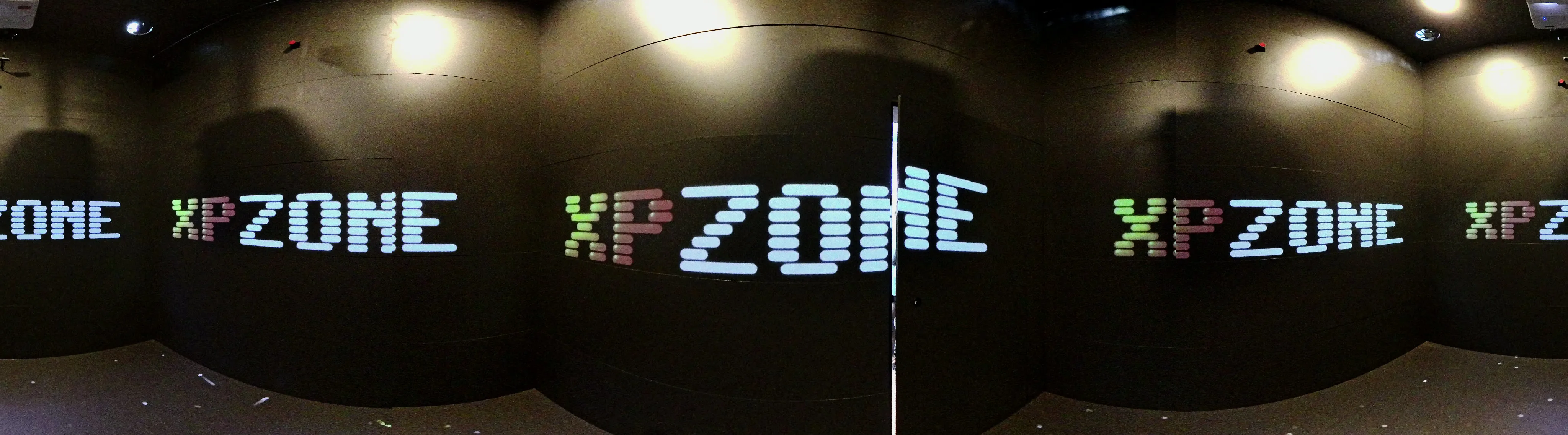 Panorama of the room: XP ZONE tiles repeating around the walls