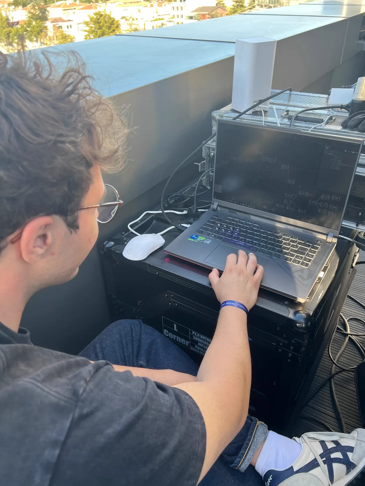 The rig from above: the laptop, the road case, the operator
