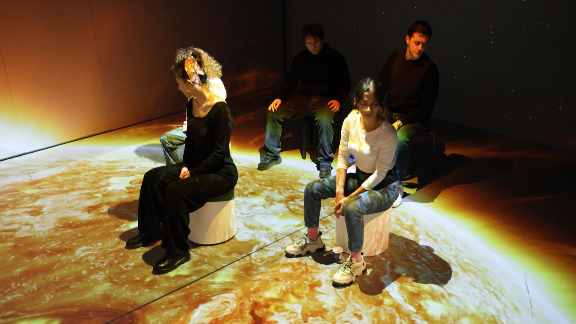 Installed: four visitors seated on the surface of the Sun